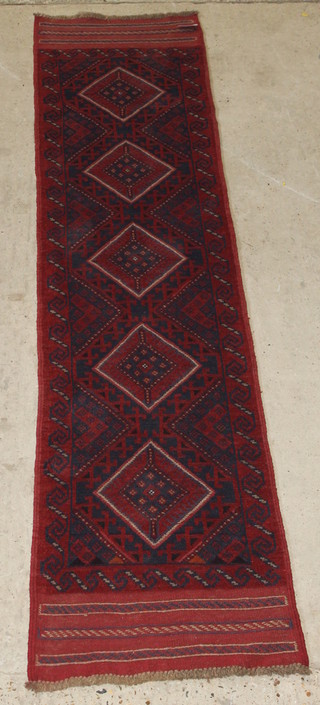 A Meshwani red ground runner having 5 octagons to the centre 104" x 23" 
