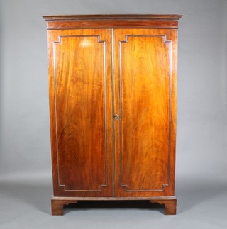 A 19th Century mahogany wardrobe with moulded cornice, enclosed by a pair of panelled doors, raised on bracket feet 67"h x 45"w x 21"d 
