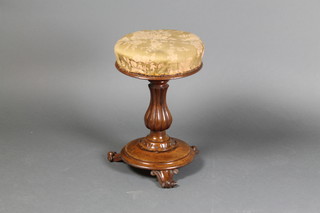 A Victorian turned mahogany revolving adjustable piano stool raised on a bulbous turned column, scroll feet 18" x 12" diam. 