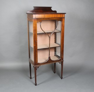 An Edwardian Art Nouveau mahogany display cabinet with raised back, fitted shelves enclosed by astragal glazed panelled doors, raised on square tapering supports, spade feet, 54"h x 24"w x 12"d 