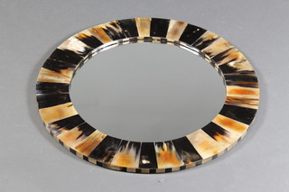 A circular plate wall mirror contained in a decorative frame 28" 