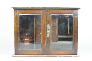 An Edwardian Art Nouveau smokers cabinet with clay pipe, fitted 2 drawers enclosed by glazed panelled doors  11"h x 14 1/2"w x 6 1/2"d