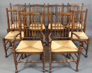 A set of 8 18th Century style elm spindle back dining chairs with woven rush drop in seats, raised on club supports - 2 carvers, 6 standard