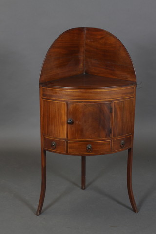 A Georgian mahogany bow front corner wash stand with raised back, the base fitted a cupboard above a drawer, raised on splayed supports 45"h x 23"w x 18"d