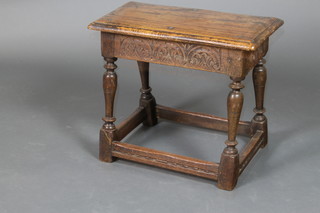 A rectangular 17th Century style carved oak joined stool raised on turned and block supports 18"h x 21"w x 11"d
