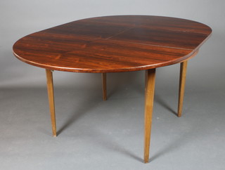 A circular 1960's Danish rosewood extending dining table with concealed extra leaf 30"h x 45"w x 46" when closed x 64 1/2" extended 