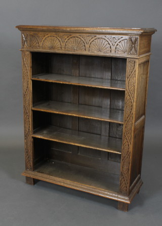 A carved oak bookcase fitted adjustable shelves 48"h x 35 1/2"w x 13" 1/2d 