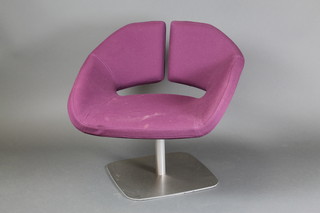 A 1960's metal framed designer revolving chair upholstered in purple material