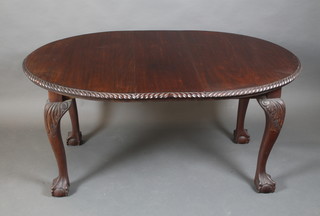 An Edwardian Chippendale style oval extending dining table with gadrooned border, having 1 extra leaf, raised on cabriole supports 28"h x 62"w x 41"d 