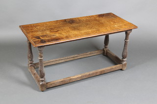 A rectangular oak occasional table, raised on turned and block supports 18 1/2"h x 37"w x 17"d