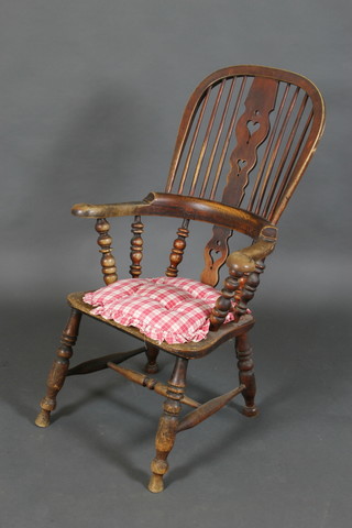A 19th Century elm stick back armchair with solid seat and H framed stretcher 