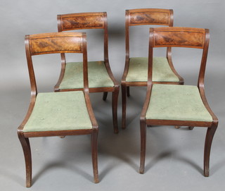 A set of 4 Georgian mahogany bar back dining chairs with upholstered drop in seats, raised on sabre supports 