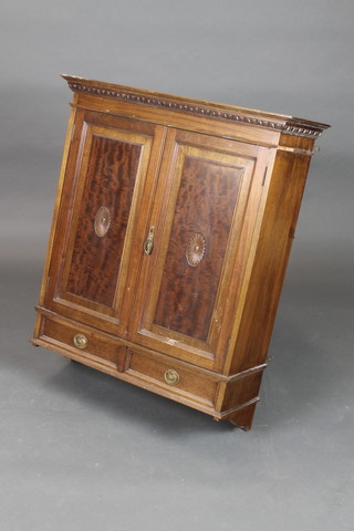 An Edwardian mahogany hanging cabinet with moulded cornice enclosed by a panelled door, the base fitted 2 long drawers 35"h x 27"w x 10"d 