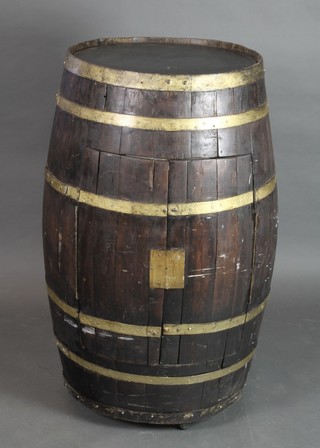 A coopered oak barrel converted to a drinks cabinet 39 1/2"h x 20" diam.