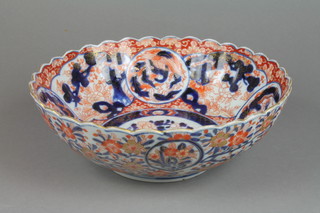 A 19th Century Imari bowl with scalloped rim and panels of dragons and flowers 10" 