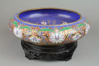 An early 20th Century cloisonne shallow bowl, the blue ground with flowering peony  12", on a wood stand