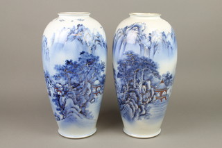 A pair of early 20th Century Japanese oviform vases decorated with pavilions and figures in boats in an extensive wooded mountainous landscape, underglazed mark to base 15" 
