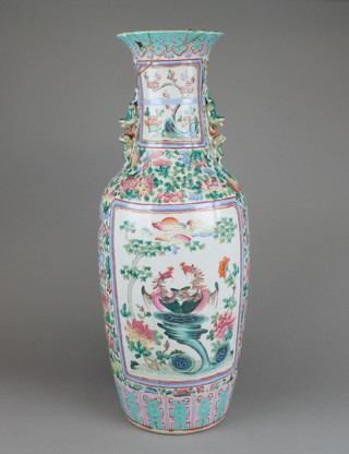 A 19th Century famille rose oviform vase with Shi Shi handles the scrolling peony ground decorated with panels of birds amongst flowers 24"h 