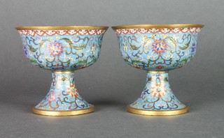 A fine pair of 19th Century gilt cloisonne cups with splayed lips and waisted bases, the mid blue ground with floral scrolling flowers and gilt interiors, signed, 4" 