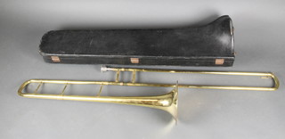 A brass trombone with 2 mouth pieces contained in a carrying case