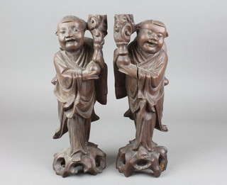 A pair of Chinese carved hardwood figures, the hardstone eyes and teeth missing, cracked 12" 