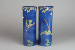 A pair of Maling blue ground cylindrical vases with gilt rims decorated with exotic birds and butterflies beneath a trail of flowers 10" 
