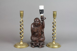 A pair of 19th Century brass spiral turned candlesticks 12" together with a Chinese carved wooden figure of a Deity converted to a table lamp (f) 
