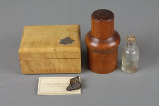Christopher Vickers.  A rippled maple trinket box decorated a silver maple leaf 1" x 3" x 2", a small section of bronze 1" and a cylindrical wooden medicine bottle case