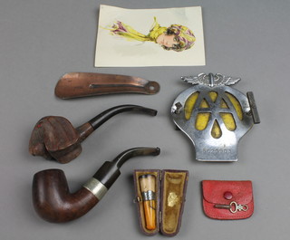2 carved wooden pipes, a copper shoe horn, an AA Beehive radiator badge, etc 