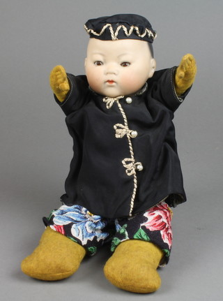 Armand Marseille, a costume porcelain headed doll in the form of a  china baby with open and shutting eyes, the head inscribed AM Germany 353/1212, with a fabric body 
