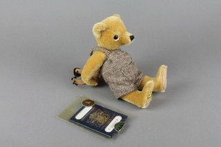 A Merrythought bear complete with passport carrying a satchel 9" 