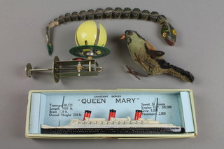 A Crescent Series model of RMS Queen Mary, boxed 8" together with a 1930's clockwork figure of a pecking bird, figure of a snake and a figure of a dog with ball 