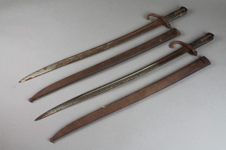 2 19th Century French chassepot bayonets, the blades dated 1868 and 1874, coroded blades and scabbards 