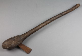 A "Arian Jaya" Western New Guinea bulbous axe with metal head 25"