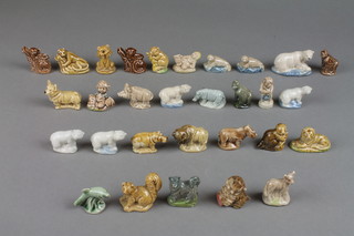 A collection of 30 Wade Whimsies comprising a polar bear, 4 cubs, 2 rhinos, 2 lions, 2 monkeys, 2 gorillas, 2 seals, a wild boar,  beaver, grey rhino, 2 dogs, reclining leopard, squirrel, a girl, boy, sabre tooth tiger, ferret, bison, fish, chimp, kitten and lamb 