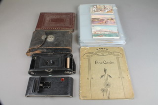 An album of various postcards The Holy Land, India and The Colonies etc, a Kodak Velosto no.1 folding camera 