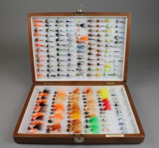 180 various tied flies contained in a walnut box 