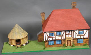 A wooden model dolls house of a timbered Tudor House with granary 41" 