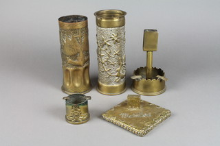 A WWI trench art shell case, the base marked 1915 decorated Royal Garrison Artillery and flags of the allies, a Continental brass shell case dated 1917 with leaf decoration, an ashtray formed form the base of an 18lb shell case dated 1916, an ashtray formed from a 40 mm anti-aircraft shell together with an embossed brass match box stand 