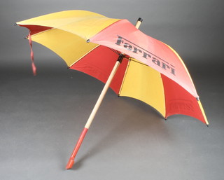 A wood shafted and fabric Ferrari umbrella 