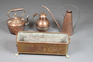 A 19th Century circular copper kettle, a Jersey style copper milk canister 9", a rectangular copper planter with brass paw feet 18" and a German Wall waisted embossed copper watering can with iron handle 13"  