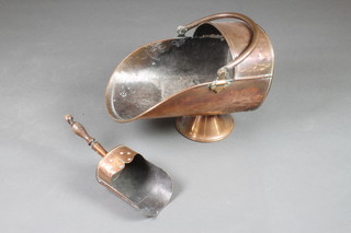 A 19th Century copper helmet shaped coal scuttle together with an Art Nouveau copper coal shovel 
