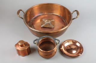 A Victorian copper twin handled preserving pan by W S Adams 16", a shaped copper caddy 4", a cylindrical copper pot with iron handle 4" and 2 circular ashtrays
