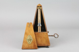 A 19th Century French metronome contained in a walnut case  