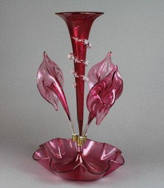 A Victorian cranberry glass epergne, the later centre trumpet of tapered form with 3 stylised lily subsidiary vases with a wavy line deep base, 19"