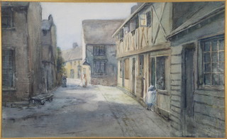 An Edwardian watercolour, a study of a street scene with a child looking into a shop window and figures in the background, unsigned 12" x 19 1/2" 