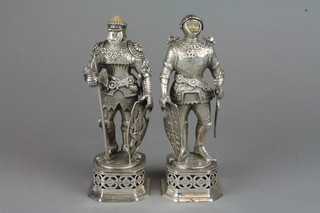 A pair of Edwardian Continental silver figures of Knights in armour, their articulated visors revealing carved ivory faces, each holding a sword and shield on raised pierced bases 7 1/2"h, approx. 624 grams 