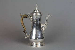 A George III silver coffee pot with scroll spout and fruit wood handle with turned finial, London 1762, 668 grams