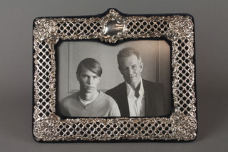 A repousse white metal photograph frame with vacant cartouche 7" x 8 1/2" 