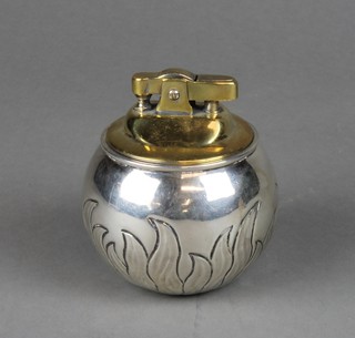 A silver spherical table lighter decorated with flames, London 1958